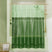 Green shower curtain with wavy pattern in a bathroom setting