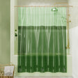 Green shower curtain with wavy pattern in a bathroom setting