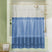Clear shower curtain with blue bottom section in a bathroom setting
