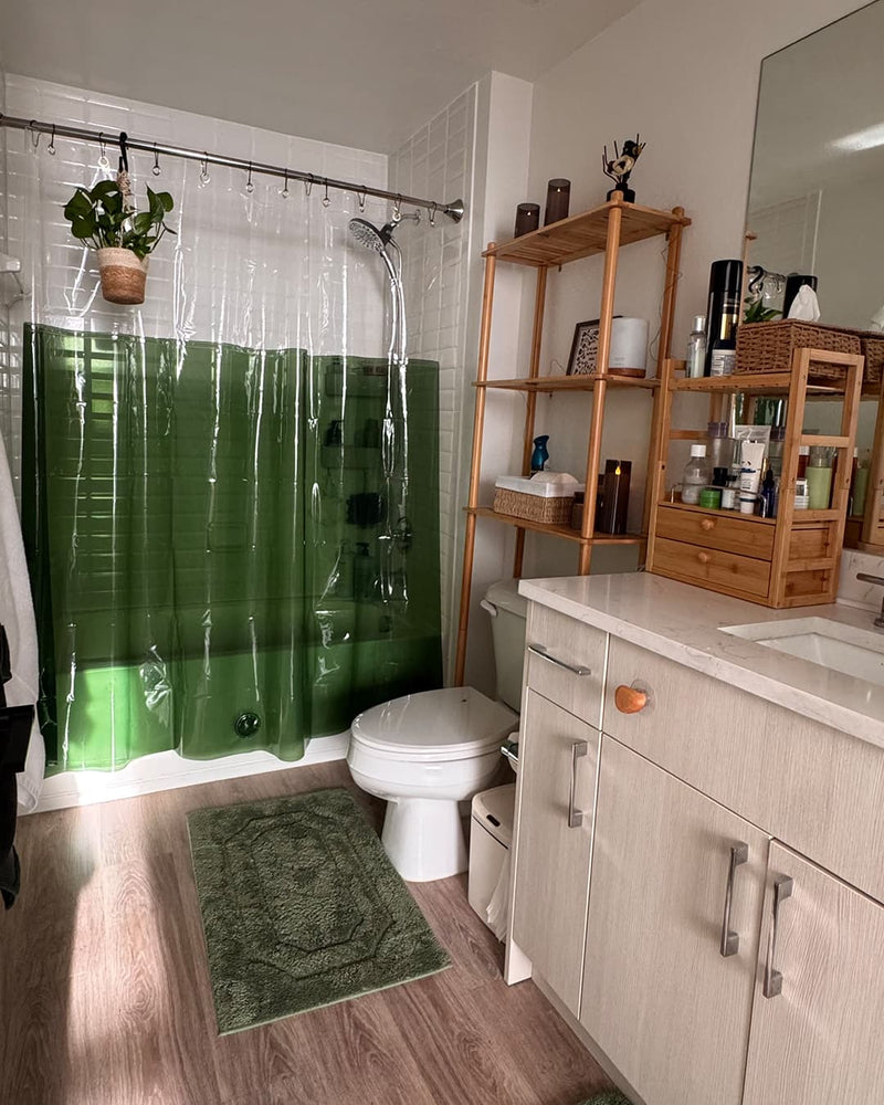 Bathroom with green shower curtain, rug, and bamboo wooden storage shelves.