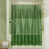 Green shower curtain in a bathroom with gold fixtures