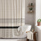 Striped shower curtain with black band in a bathroom setting