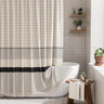Striped shower curtain with black band in a bathroom setting