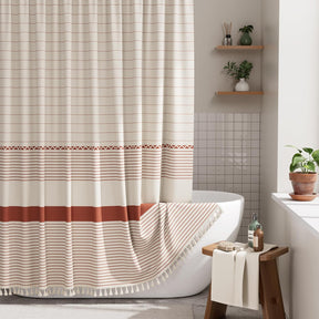 Bathroom with a striped shower curtain, bathtub, and wooden stool.
