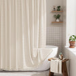 Bathroom with a white bathtub, shower curtain, and wooden stool.