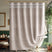 Beige shower curtain with white fringe in a bathroom setting