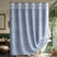 Blue shower curtain with white fringe trim in a bathroom setting