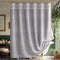 Gray shower curtain with decorative top trim in a bathroom setting.