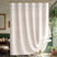 Beige shower curtain with white fringe in a bathroom setting