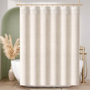 Beige striped shower curtain in a bathroom with a bathtub and decorative elements.