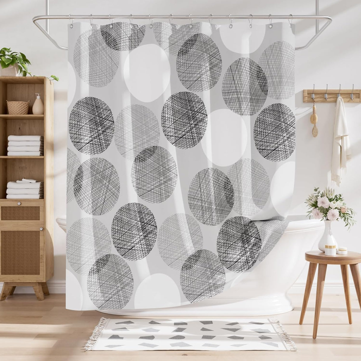 Shower curtain with black and white circular pattern in a bathroom setting