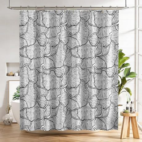 Shower curtain with black and white floral pattern in a bathroom setting