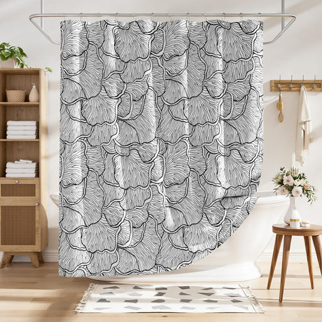 Shower curtain with black and white leaf pattern in a bathroom setting