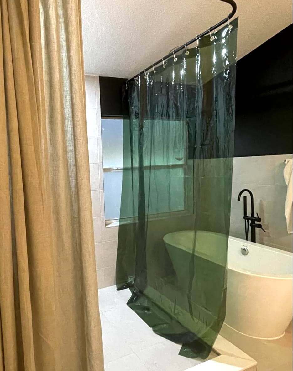 Orange shower curtain in a tiled shower