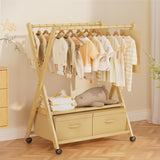 Wooden clothing rack with baby clothes and toys in a nursery setting