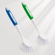 Two kitchen brushes with blue and green handles on a white background