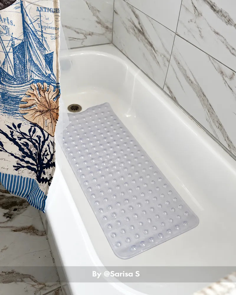 Customer bathroom photo showing a large bathtub mat placed beside or inside a tub, with the mat visible in the bath setting.