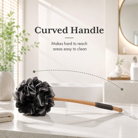 Black loofah scrubber with curved handle on a bathroom counter
