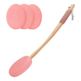 Pink silicone scrubber with wooden handle and three additional pink pads on a white background