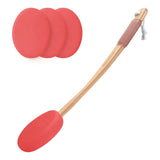 Red silicone spatula with wooden handle and three additional red silicone pads on a white background