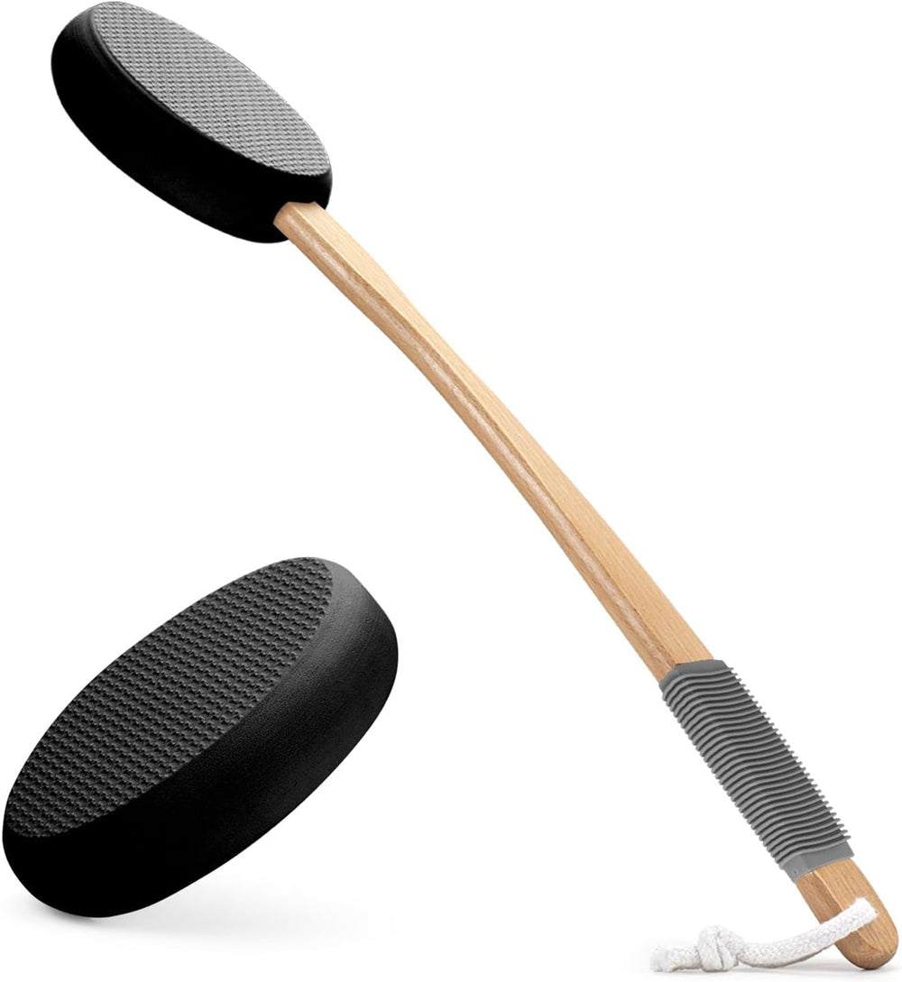 Black massage paddle with wooden handle on a white background