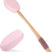 Two pink scrubbing brushes with wooden handles on a white background