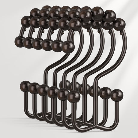 Set of black metal hooks with wooden knobs on a white background