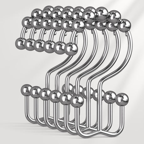 Metallic hook rack with spherical ends on a white background