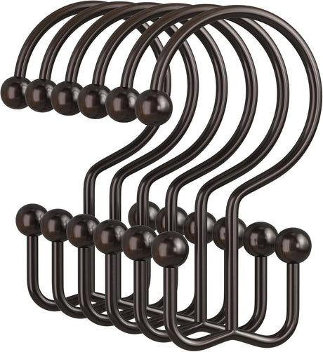 Set of black hooks with wooden knobs on a white background