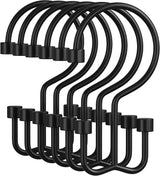 Set of black metal hooks on a white background