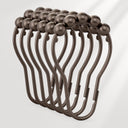 Set of bronze curtain hooks on a white background