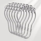 Set of silver curtain hooks on a white background