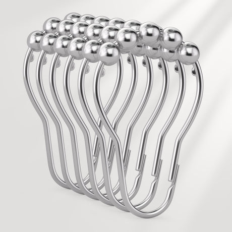 Set of silver curtain hooks on a white background