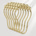 Set of gold safety pins on a light gray background