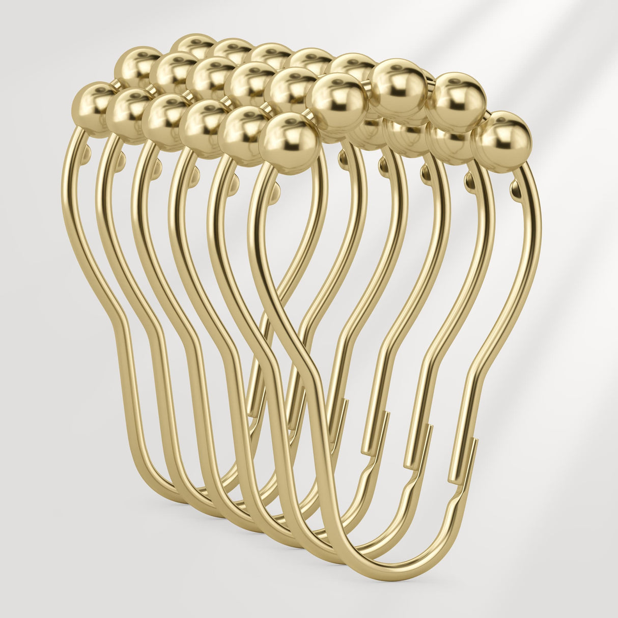 Set of gold safety pins on a light gray background