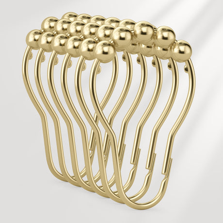 Set of gold safety pins on a light gray background