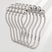 Metallic hair clip with pearl-like beads on a light gray background