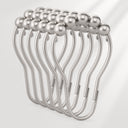 Metallic hair clip with pearl-like beads on a light gray background