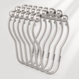 Metallic hair clip with pearl-like beads on a light gray background