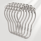 Set of silver curtain hooks on a white background