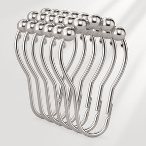 Set of silver curtain hooks on a white background