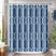 Shower curtain with geometric pattern in blue and white, hanging in a bathroom.