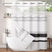 Striped shower curtain with a white bathtub and bathroom decor.