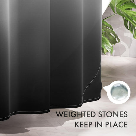 Black shower curtain with text 'Weighted stones keep in place' on a bathroom floor.