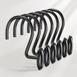Set of black metal hooks with decorative elements on a white background