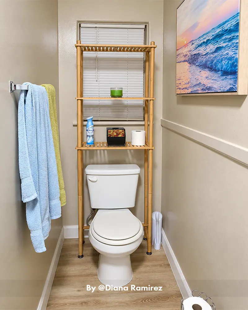 AmazerBath bamboo over-the-toilet storage rack in a real bathroom, organizing towels, toiletries, and everyday essentials