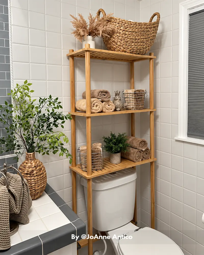 AmazerBath bamboo over-the-toilet shelf styled in a real bathroom with organized toiletries and decorative accessories