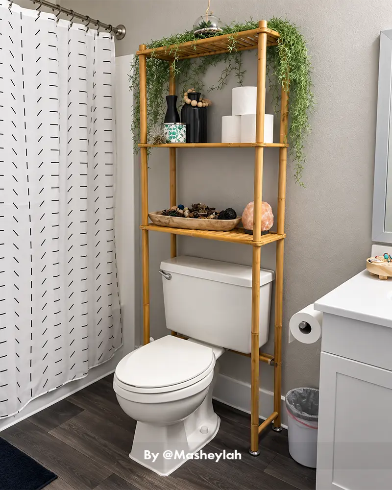 AmazerBath bamboo toilet storage organizer with tiered shelves holding practical bathroom essentials in a customer home
