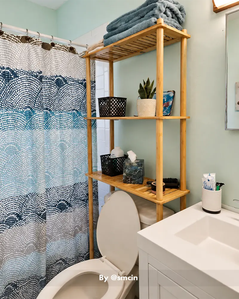 AmazerBath natural bamboo bathroom organizer above a toilet, showing convenient tiered storage in a customer bathroom