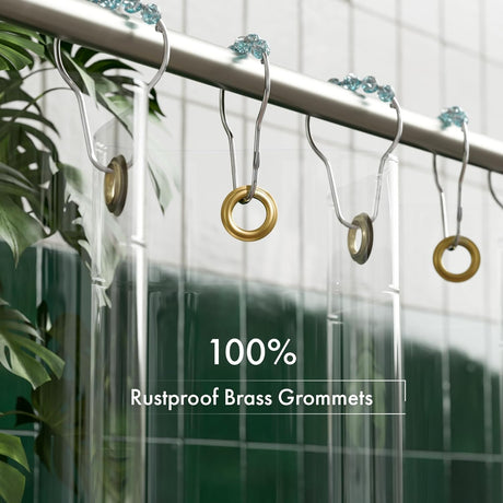 Shower curtain hooks with brass grommets on a curtain, with plants in the background.